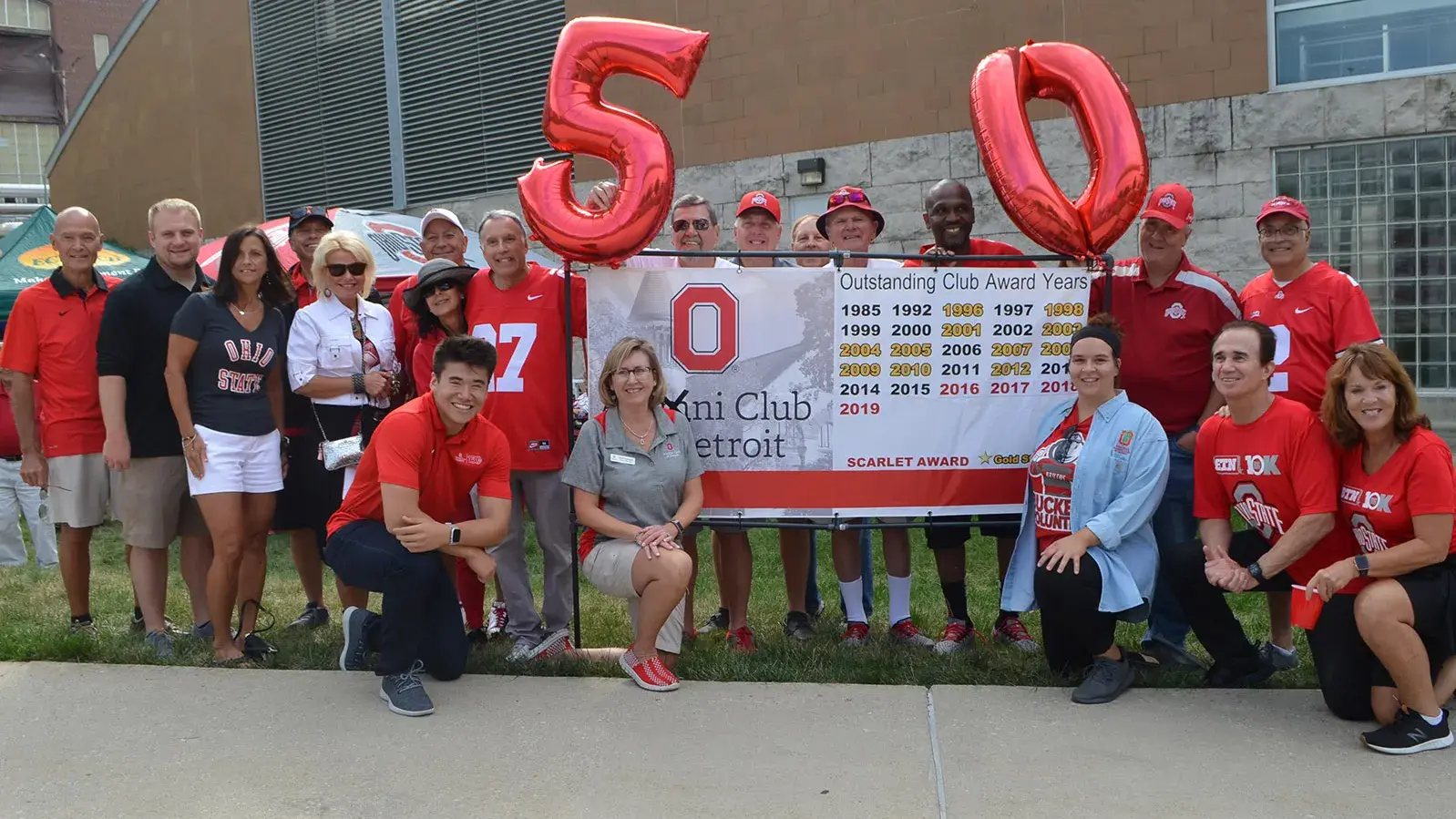 dozens of people wearing scarlet and gray