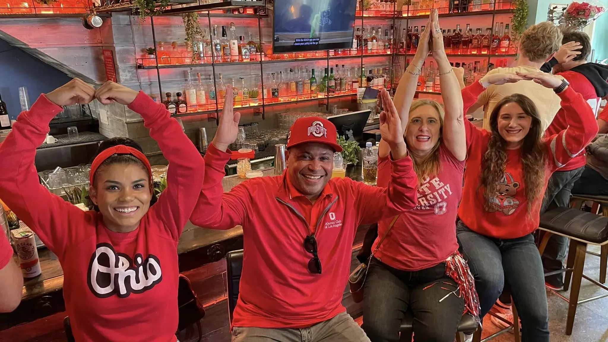 four people pose for o-h-i-o photo