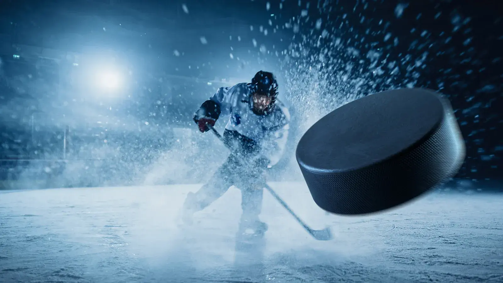 hockey player shooting a hockey puck