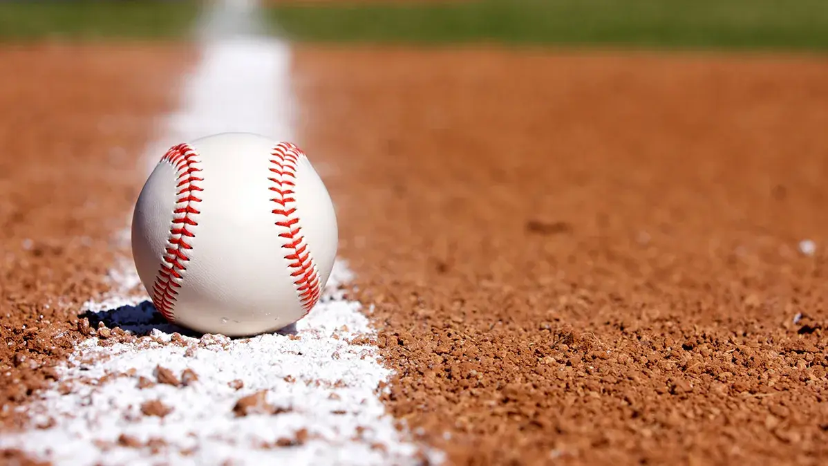 baseball sitting on a white foul line
