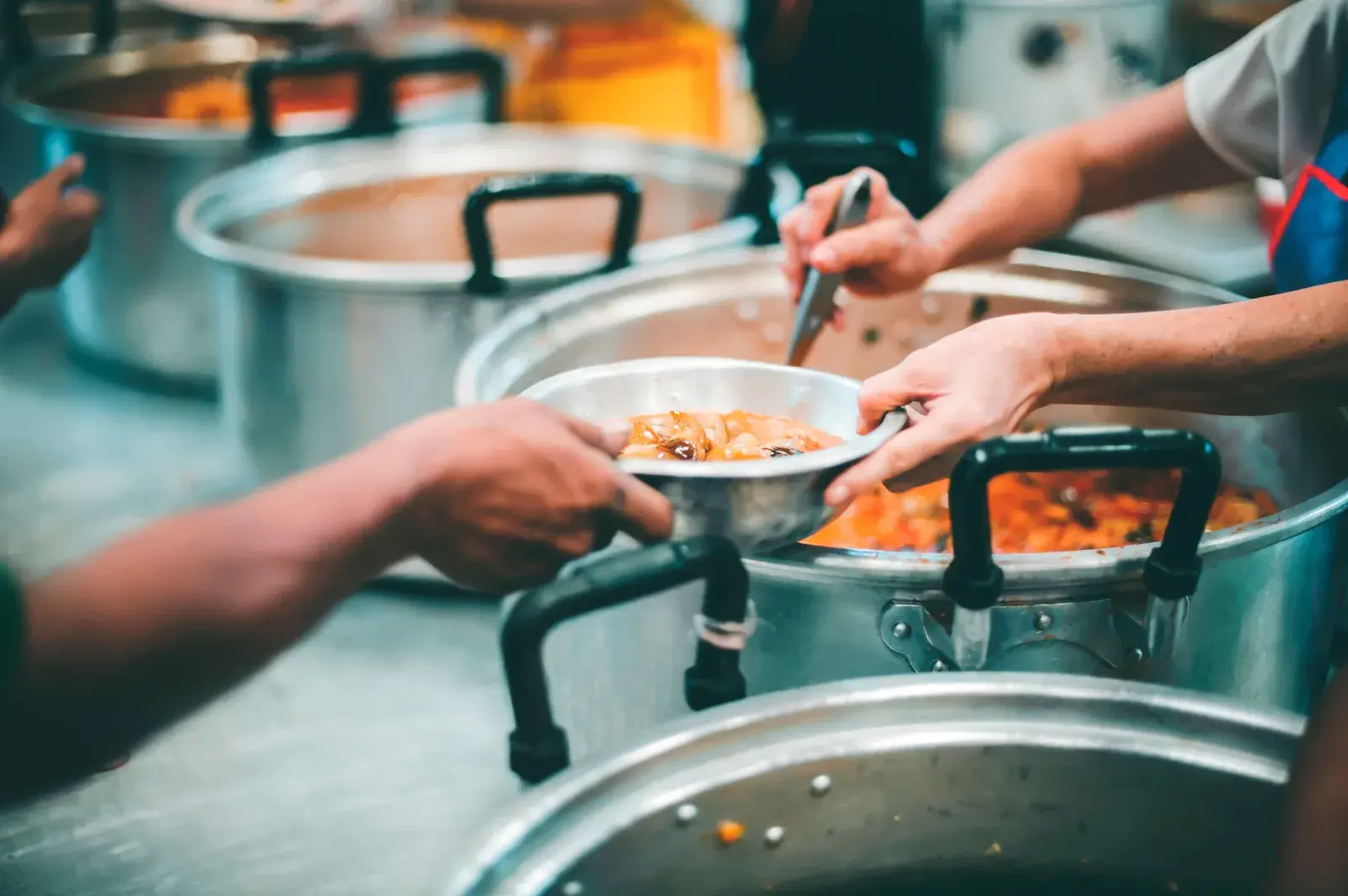 People volunteering at soup kitchen