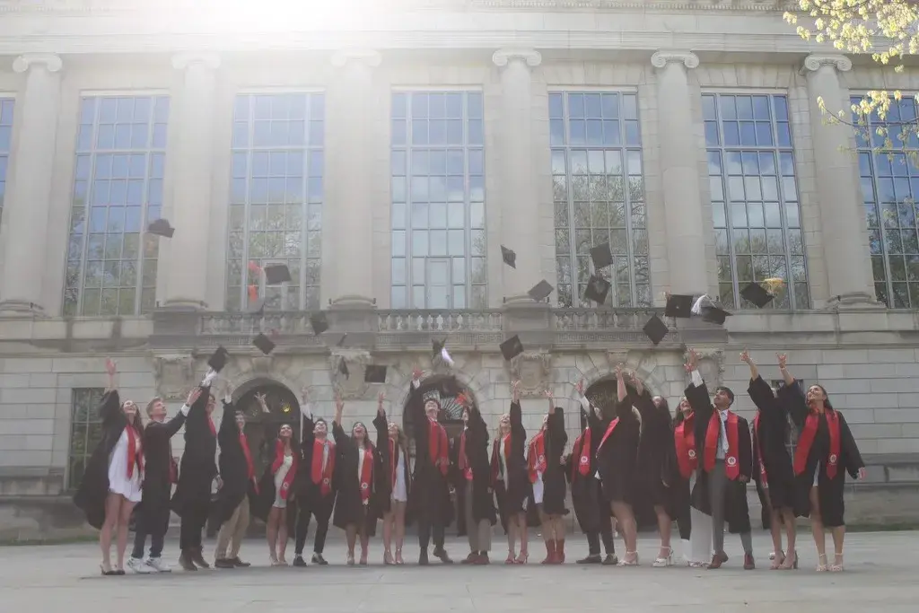 2024 Graduating seniors wearing their gowns and throwing their caps