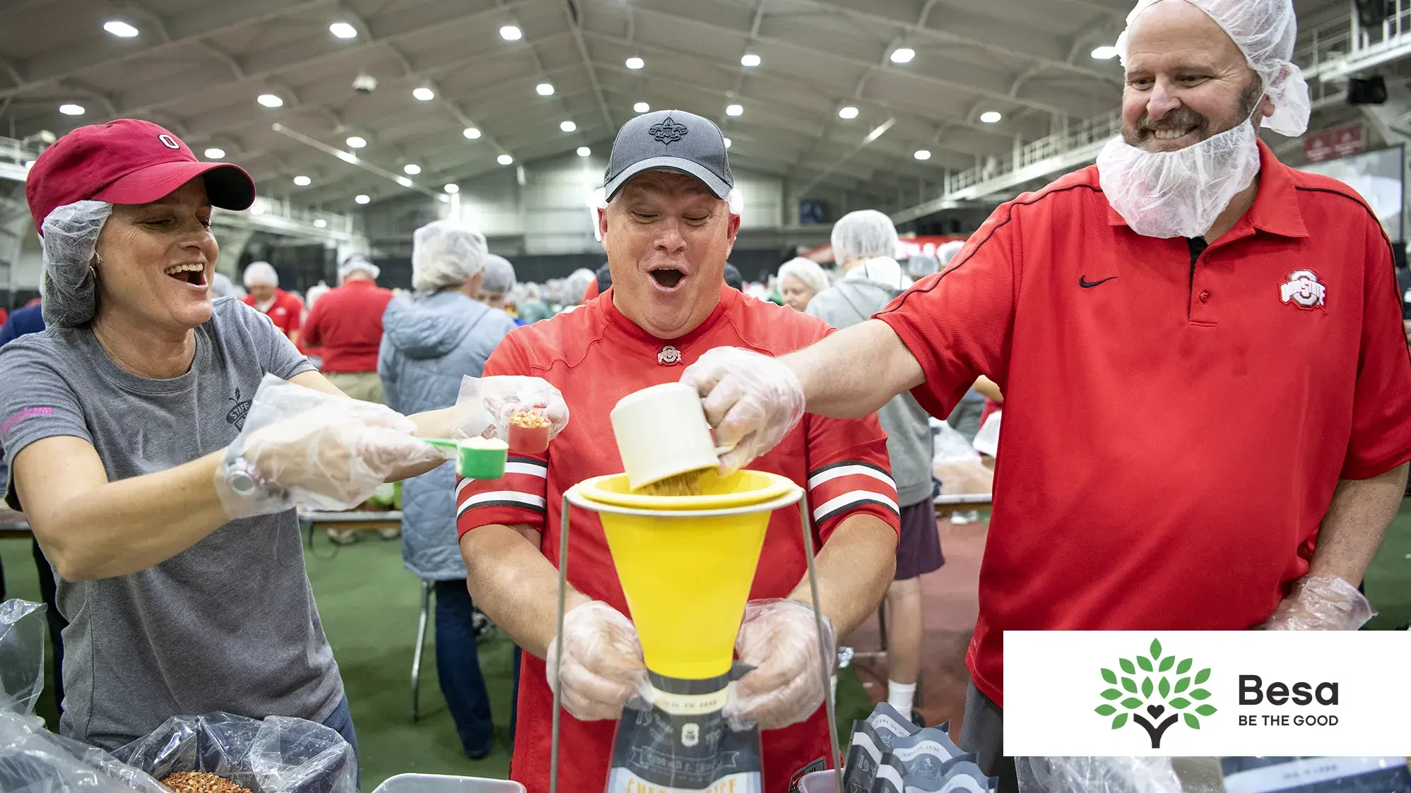 three volunteers prepare meals at a pack shack event