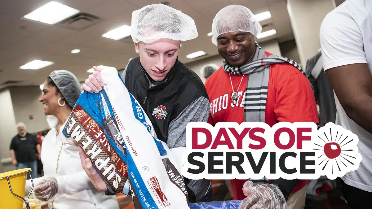 two people at a volunteer event to pack meals