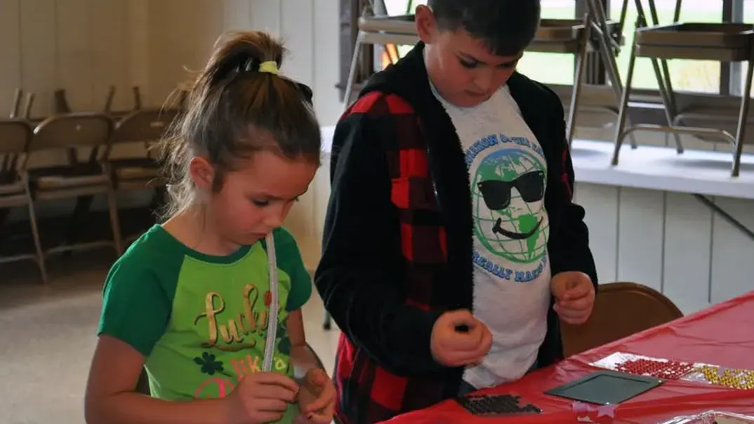 two children completing crafts