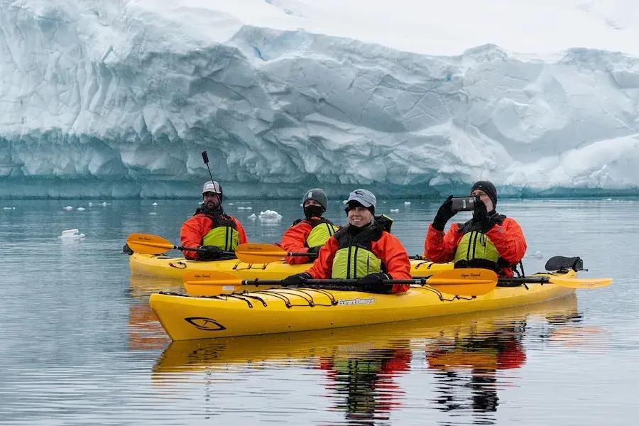 Travelers in two yellow kayaks on the water