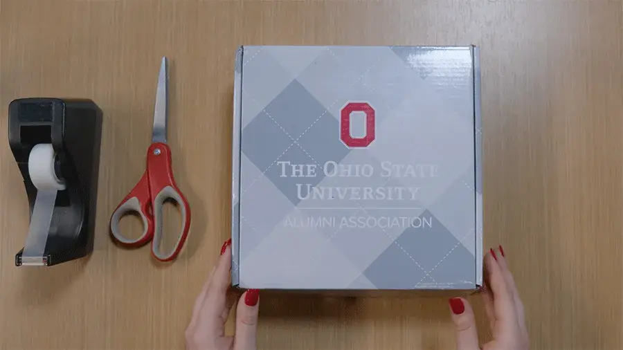 Crafternoon video tutorial 1 with a box, scissors and a roll of scotch tape sitting on a table