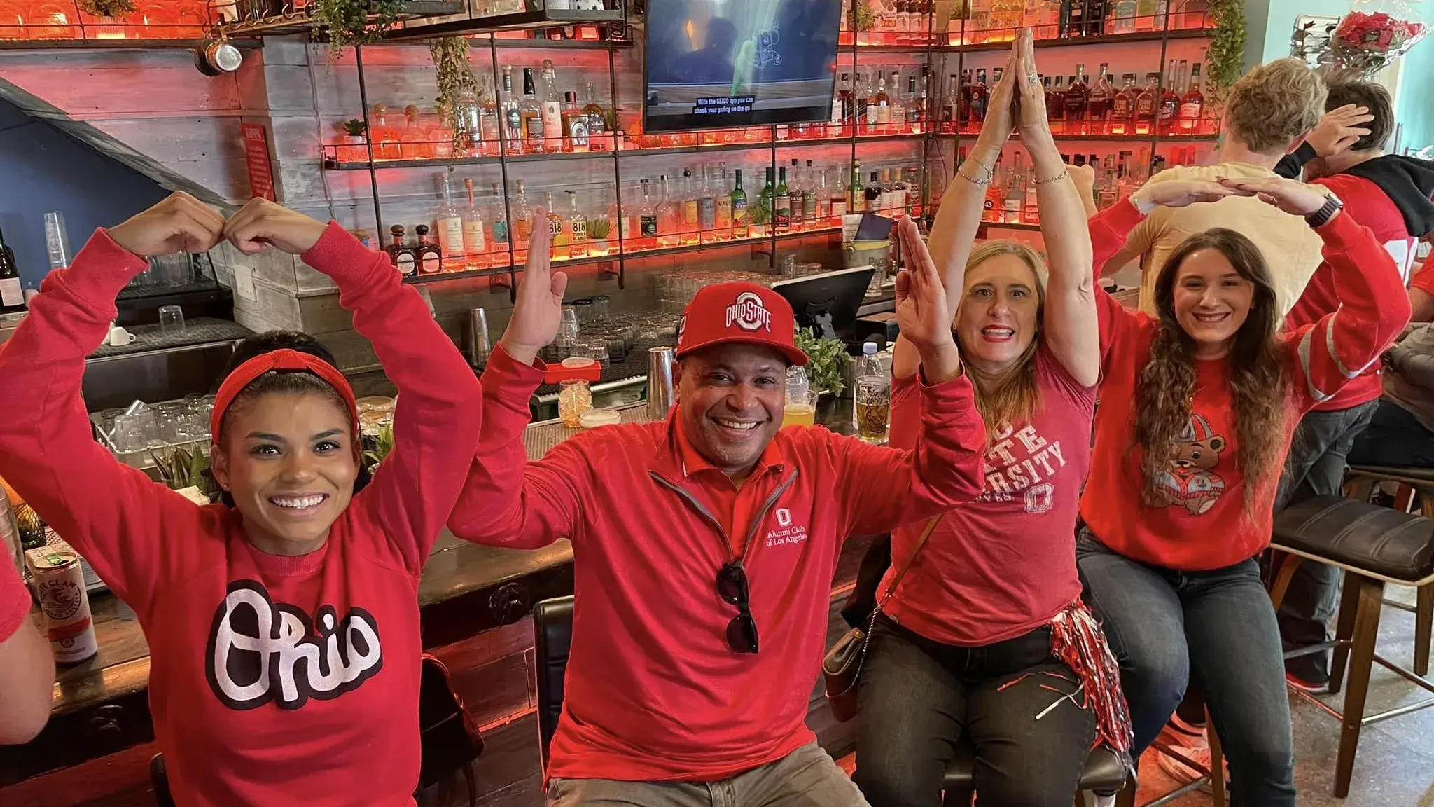 four people pose for o-h-i-o photo
