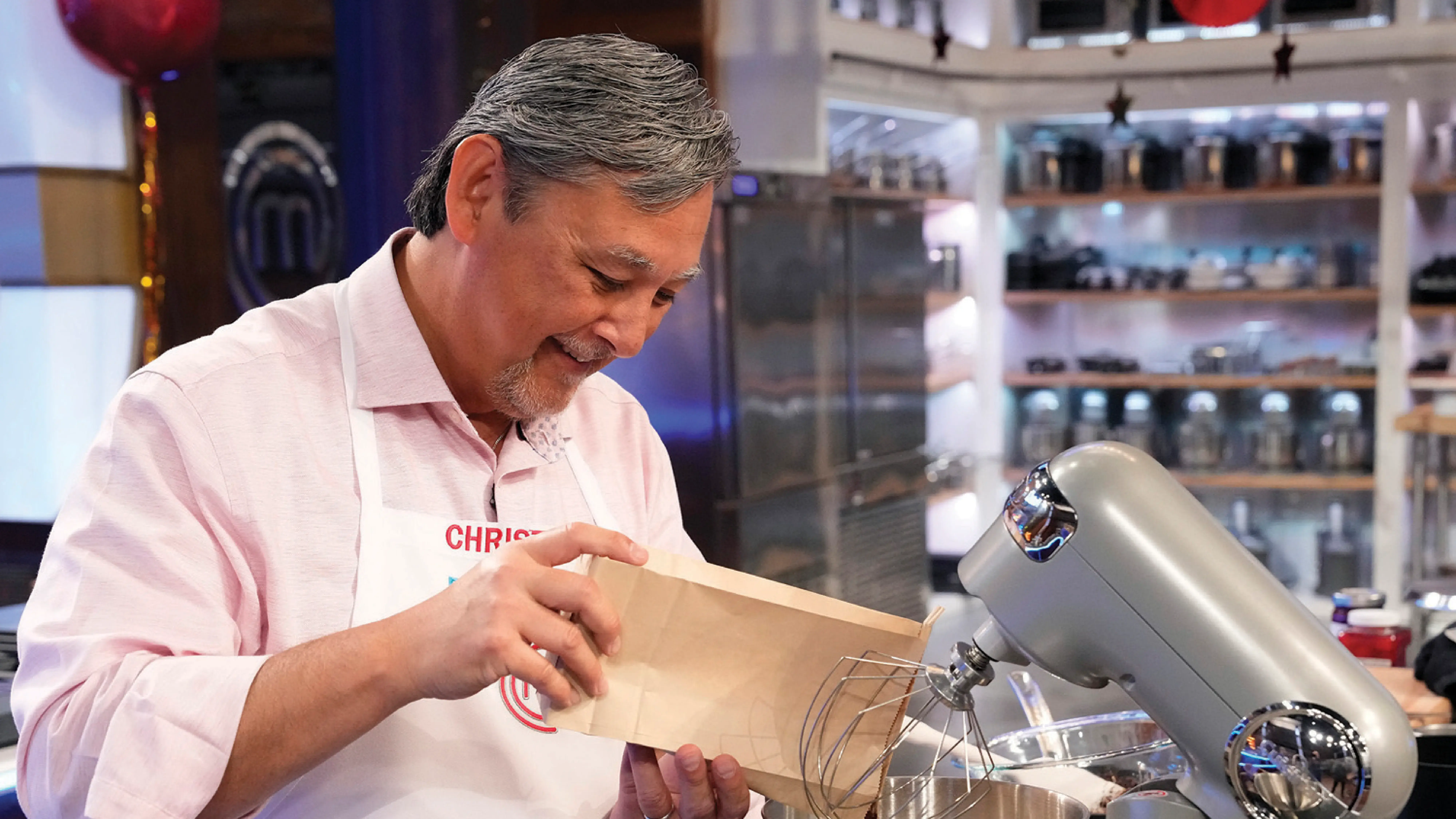 Chef Chris Walinski pouring an ingredient into a mixer.