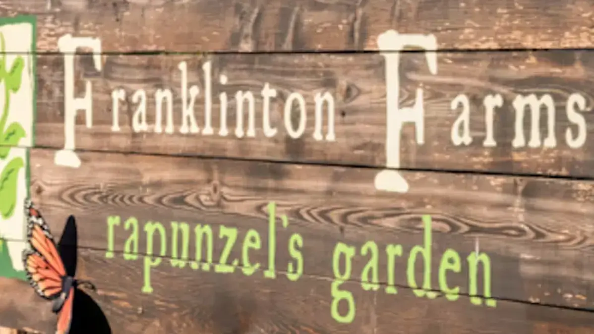 wooden sign with the words franklinton farms