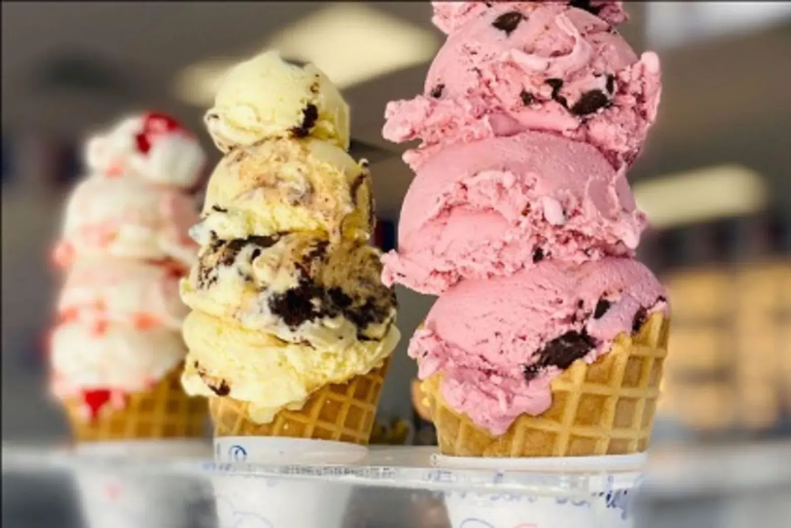 a row of ice strawberry and vanilla cream on cones