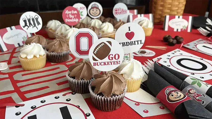 Buckeye-themed decorations and cupcakes on a table