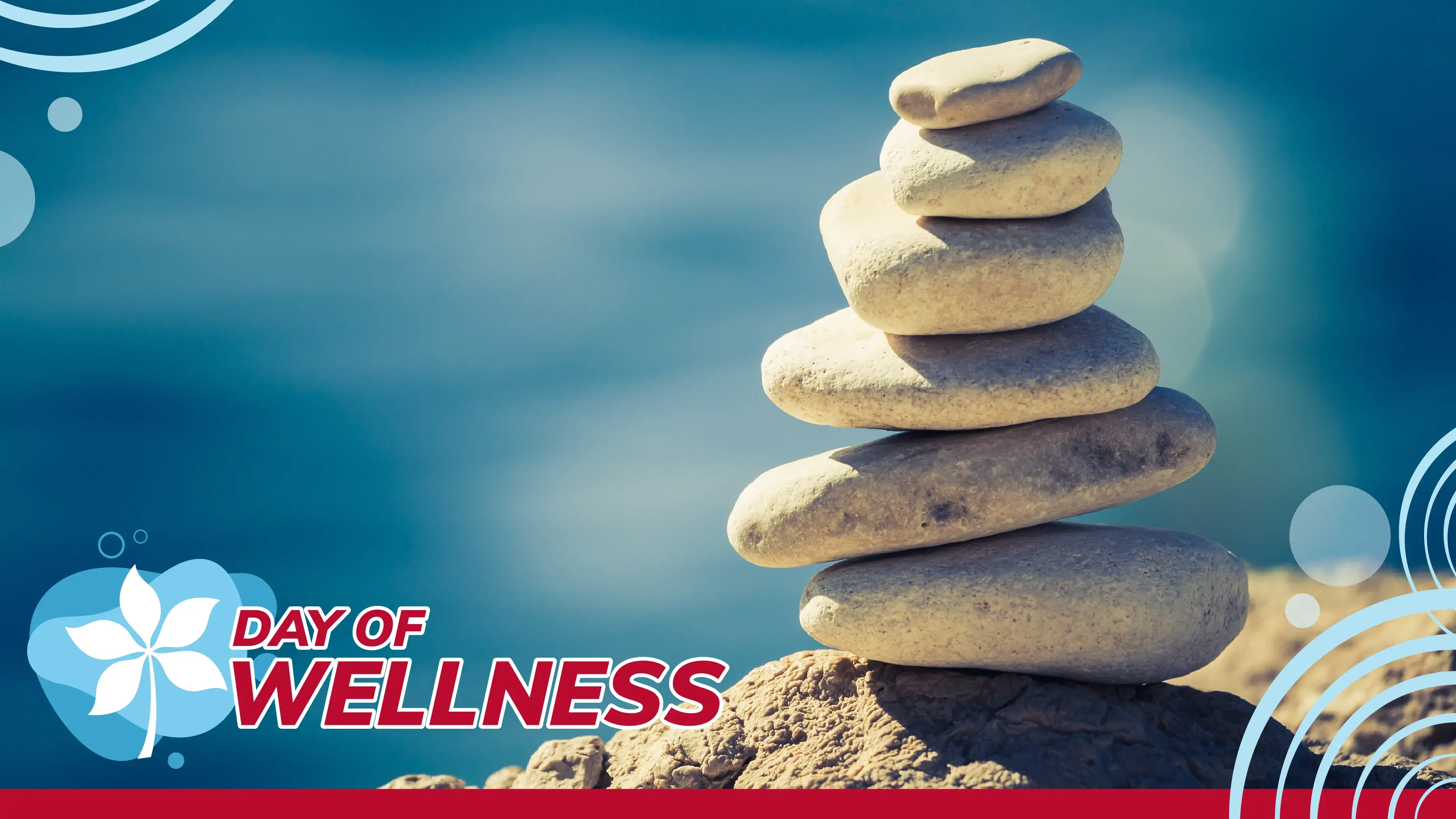 a stack of several stones with text reading Day of Wellness