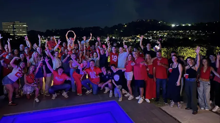 dozens of buckeyes pose for a group photo with their arms making the letter O