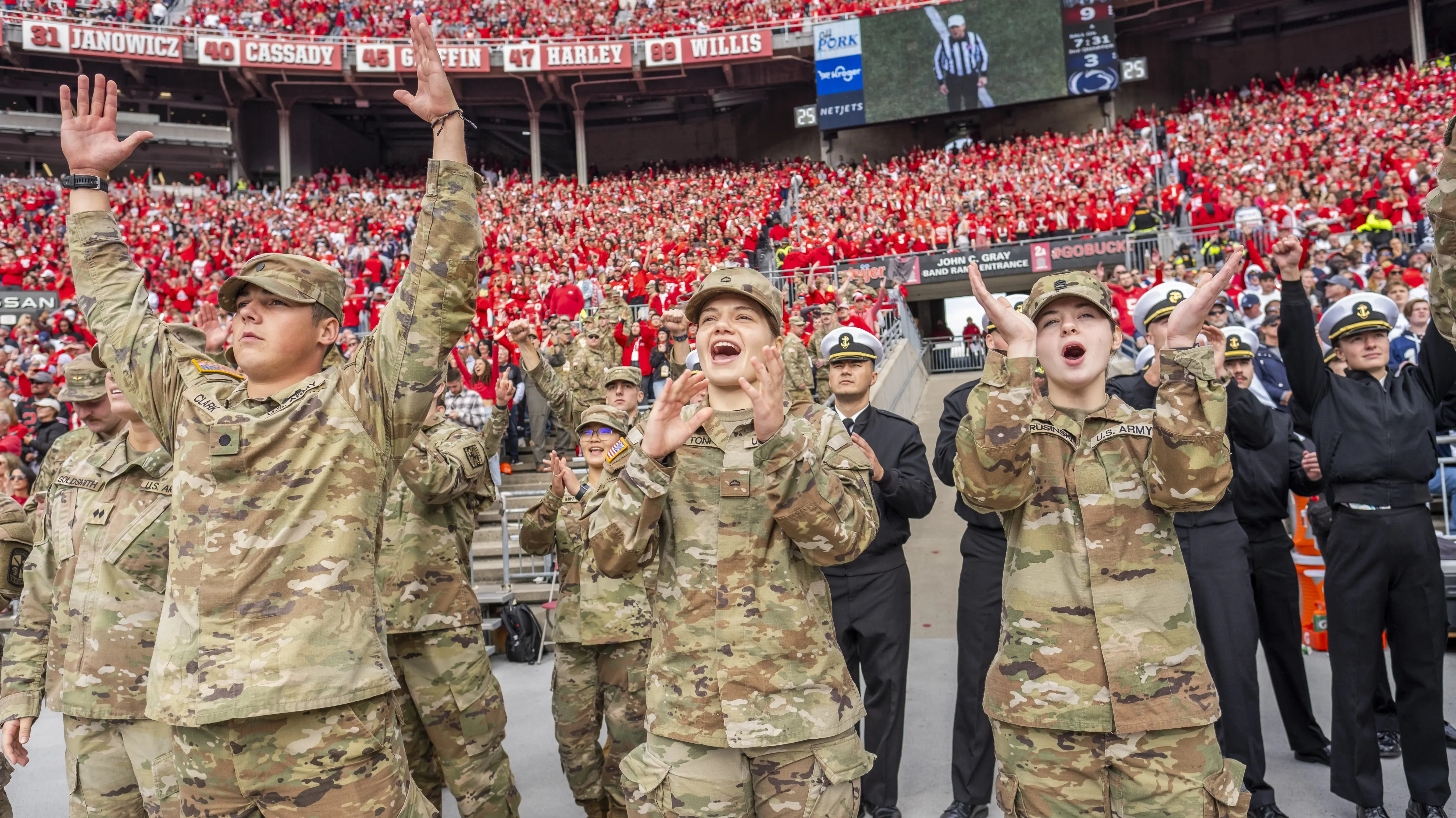 Members of the military celebrating in Ohio Stadium with Buckeye fans