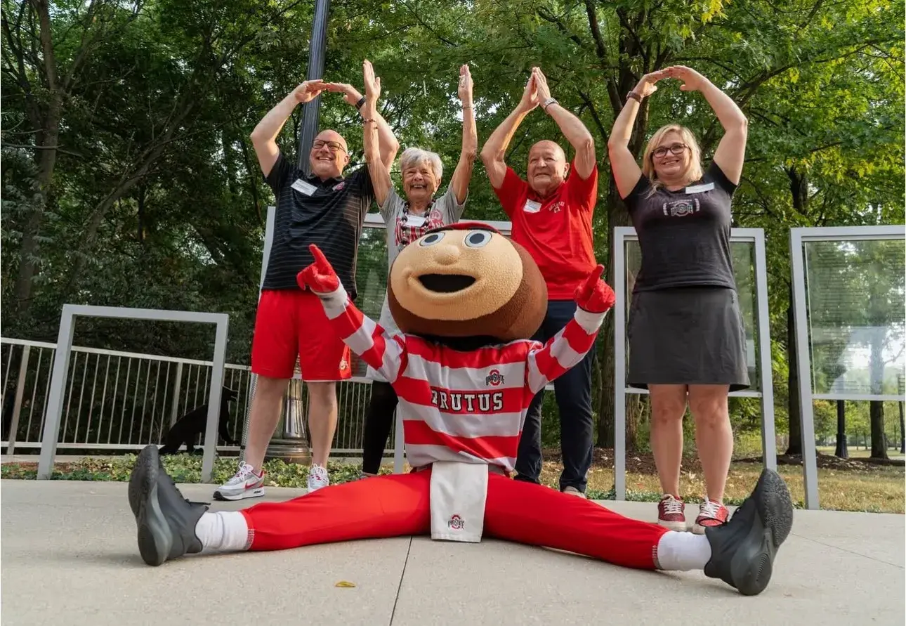 OHIO pose with greater cleveland alumni club members and brutus outside at LAH