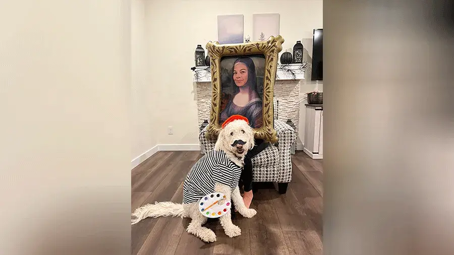 A dog dressed up as Leonardo da Vinci sitting next to a person dressed up as the Mona Lisa