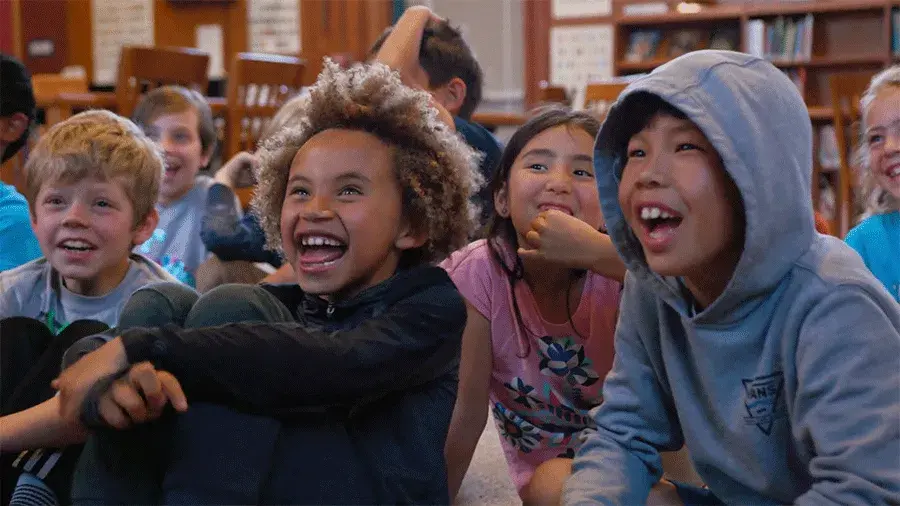 children sitting on the floor and laughing