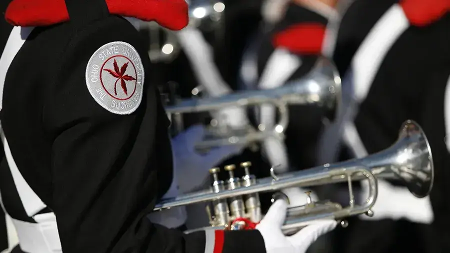 Side photo of an Ohio State Marching Band trumpet member.