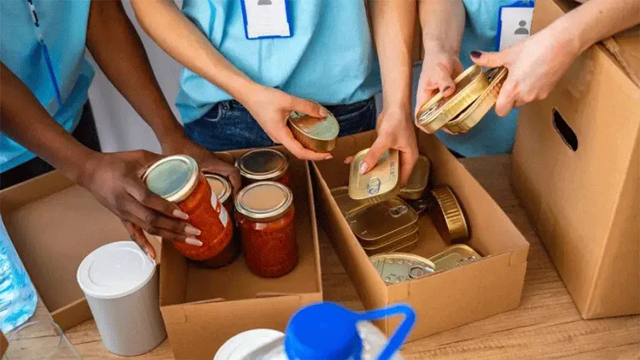 People packing boxes of food