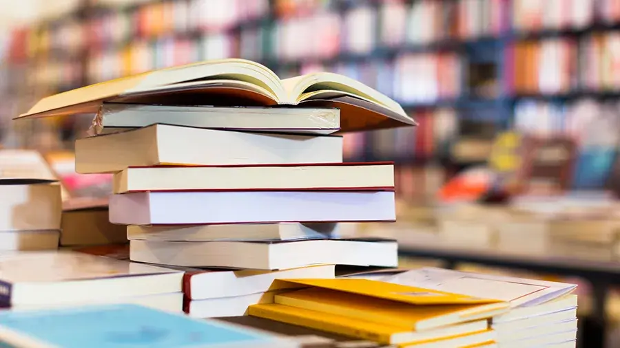 Stack of books with an open book on top