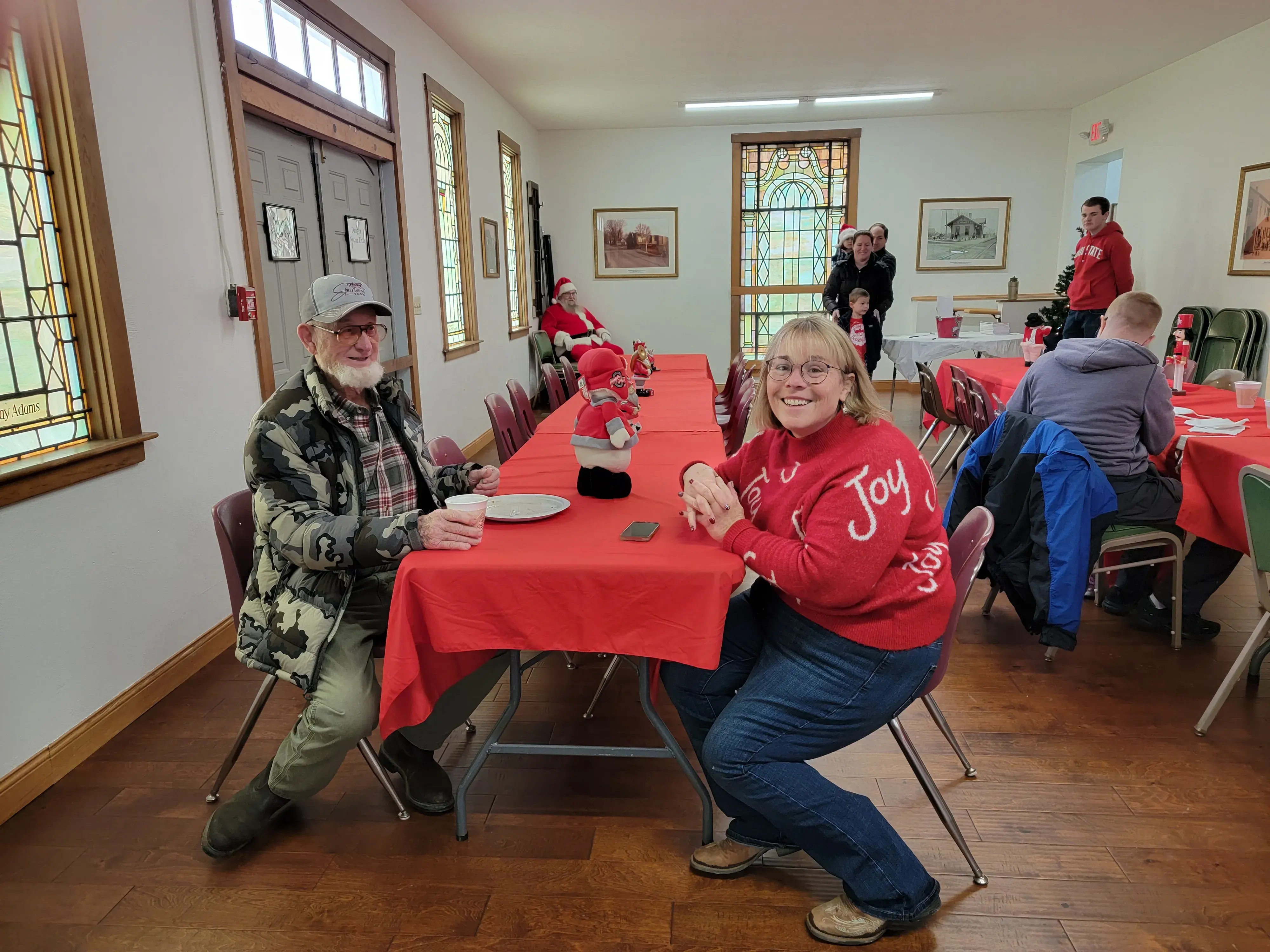 two alumni smiling for a photo at an event