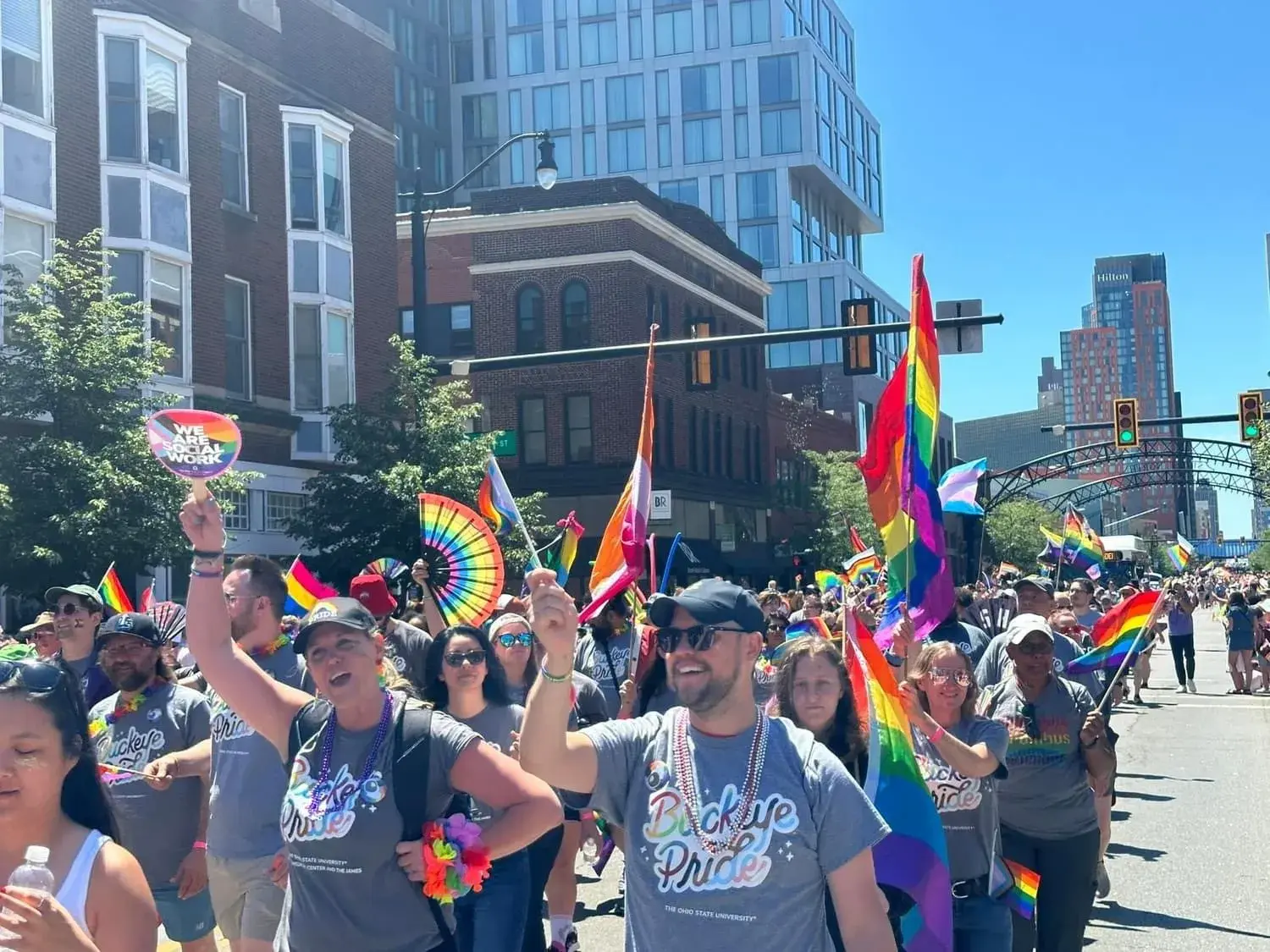 scarlet and gay alumni society waving flags at pride parade