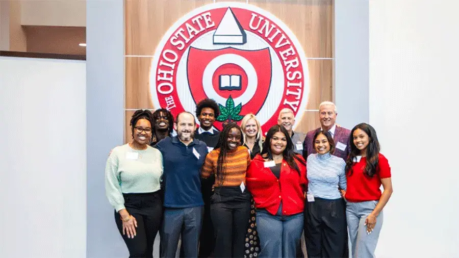 A group of Buckeyes pictured with the Ohio State University Seal