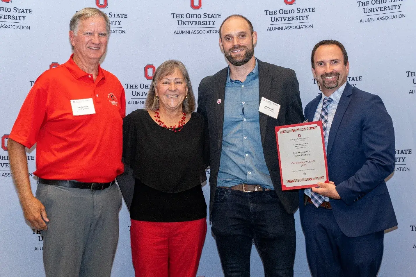 Civil engineering alumni society members hold their alumni society award and smile next to OSUAA President