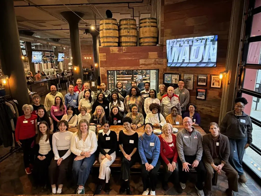 greater cleveland alumni club members gathering for a photo at a social event and smiling
