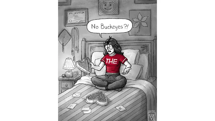 An illustrated person sitting cross‑legged on a bed holds an open heart‑shaped chocolate box and exclaims, ‘No Buckeyes?!’ The room is decorated with Ohio‑themed artwork and cozy furnishings.