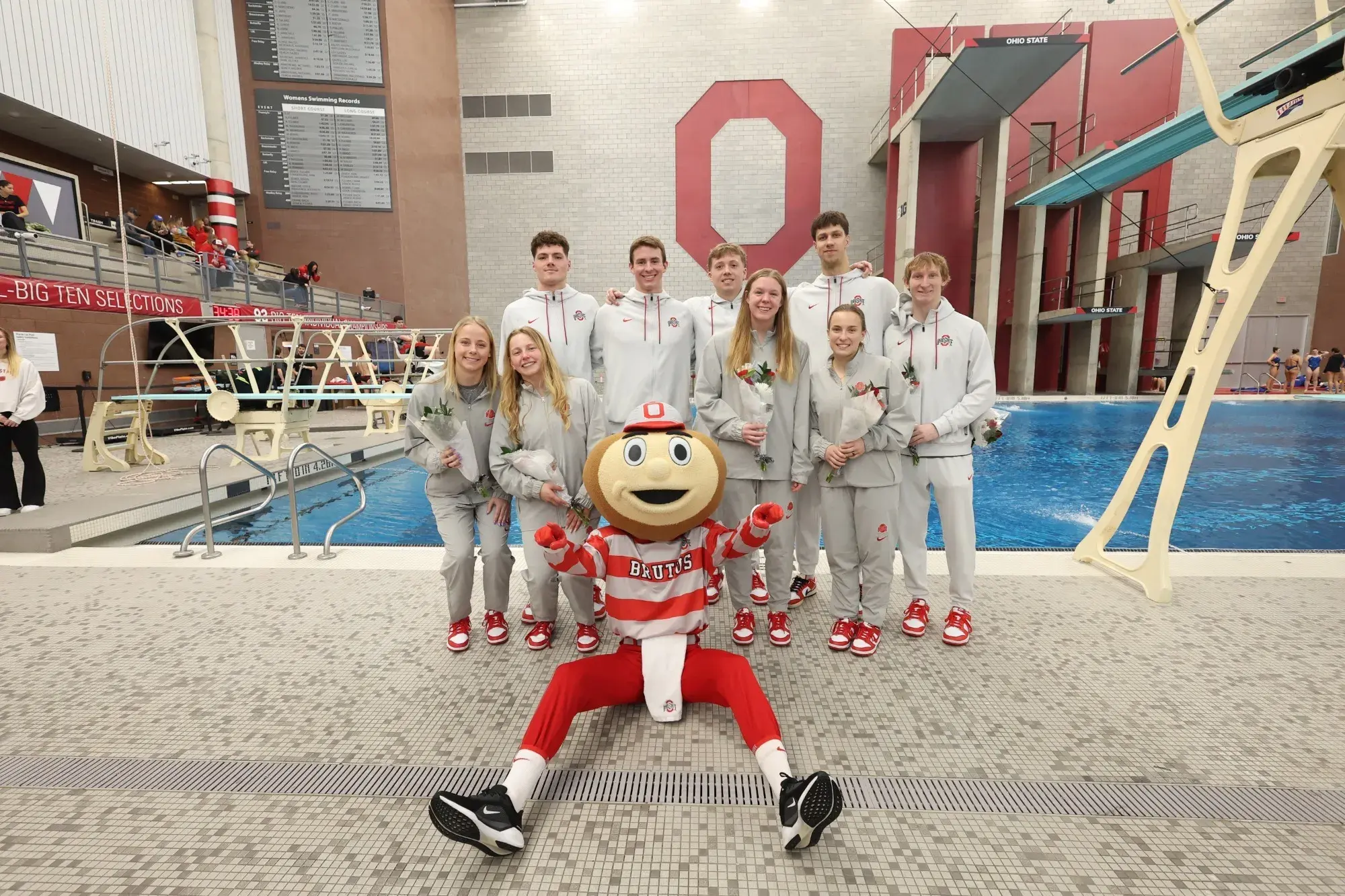 student athletes of swim team posing with Brutus.