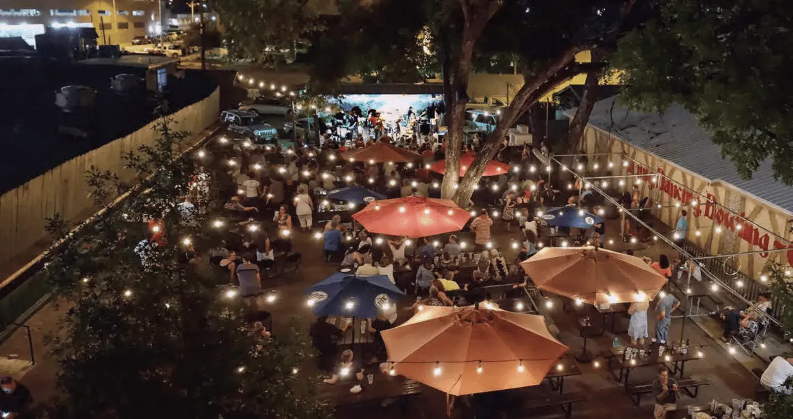 aerial view of nightime event with twinkle lights above.