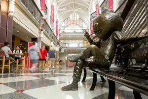 Statue of Brutus sitting on chair inside the Ohio Union building.