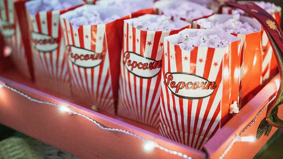 Popcorn boxes in a tray with string lights.
