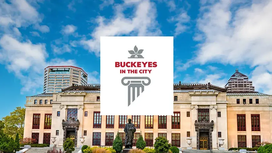 Buckeyes in the City logo over a city museum building and blue sky.