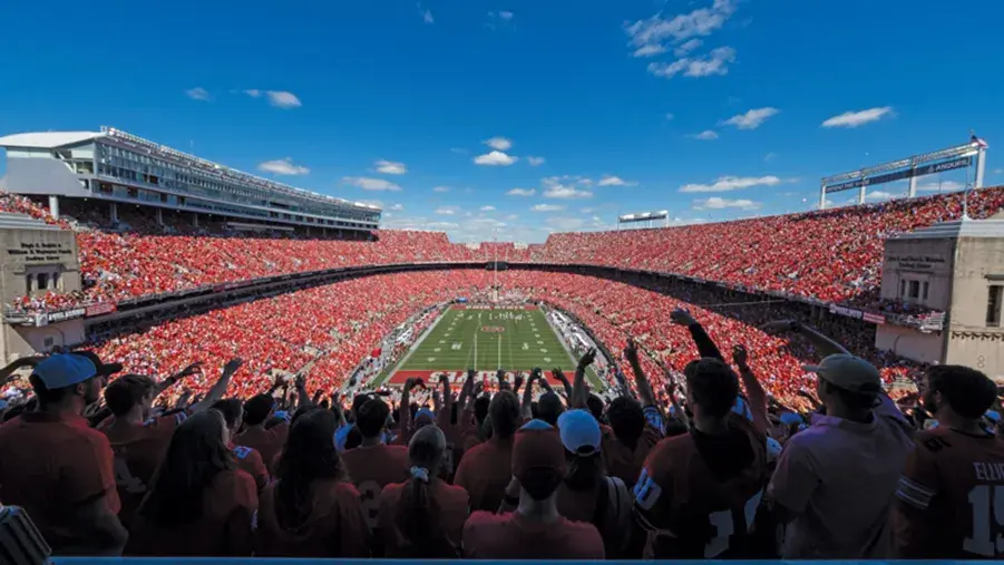 A packed Ohio Stadium on a gorgeous game day shows a sea of cheering fans. 