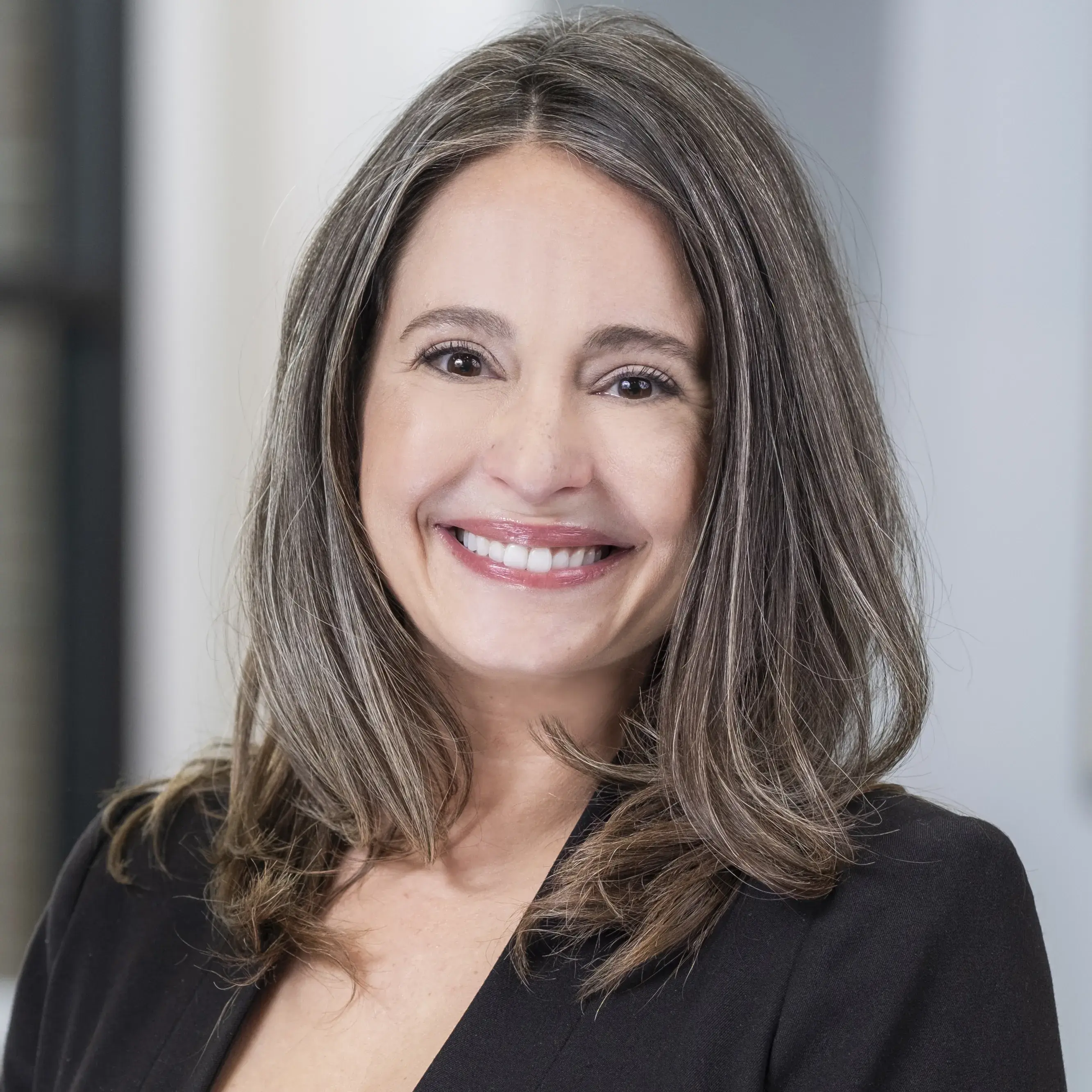 smiling woman wearing a black blazer