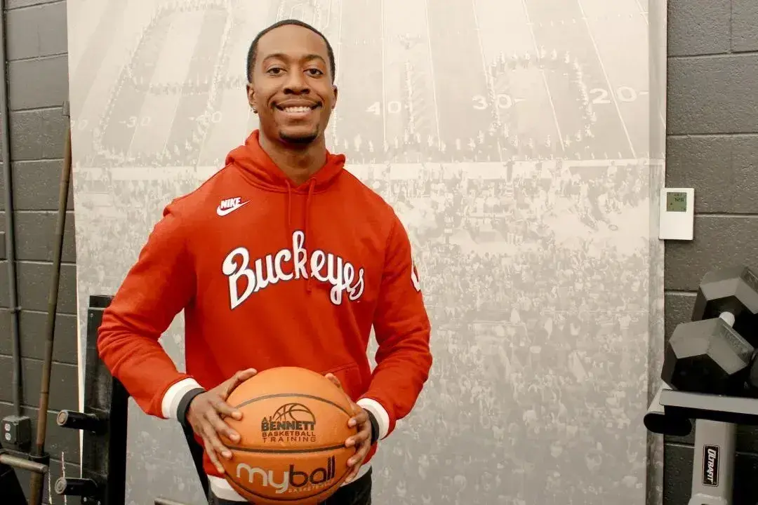 AJ Bennett holding a basketball