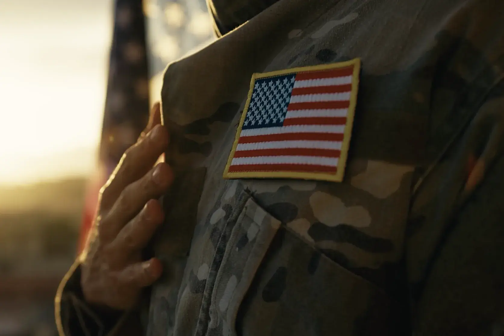 person in a united states military uniform places their hand across their chest