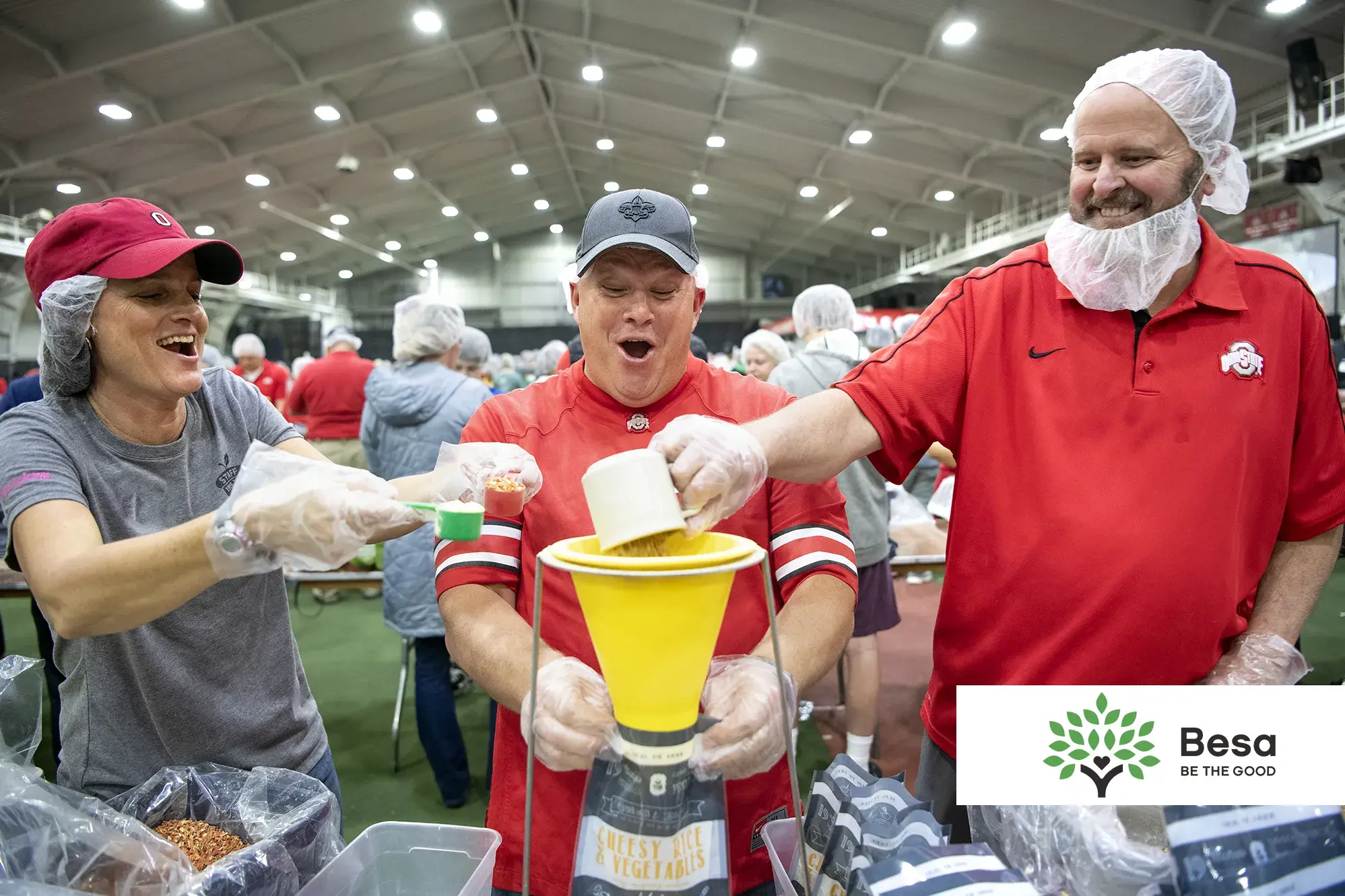 three volunteers prepare meals at a pack shack event