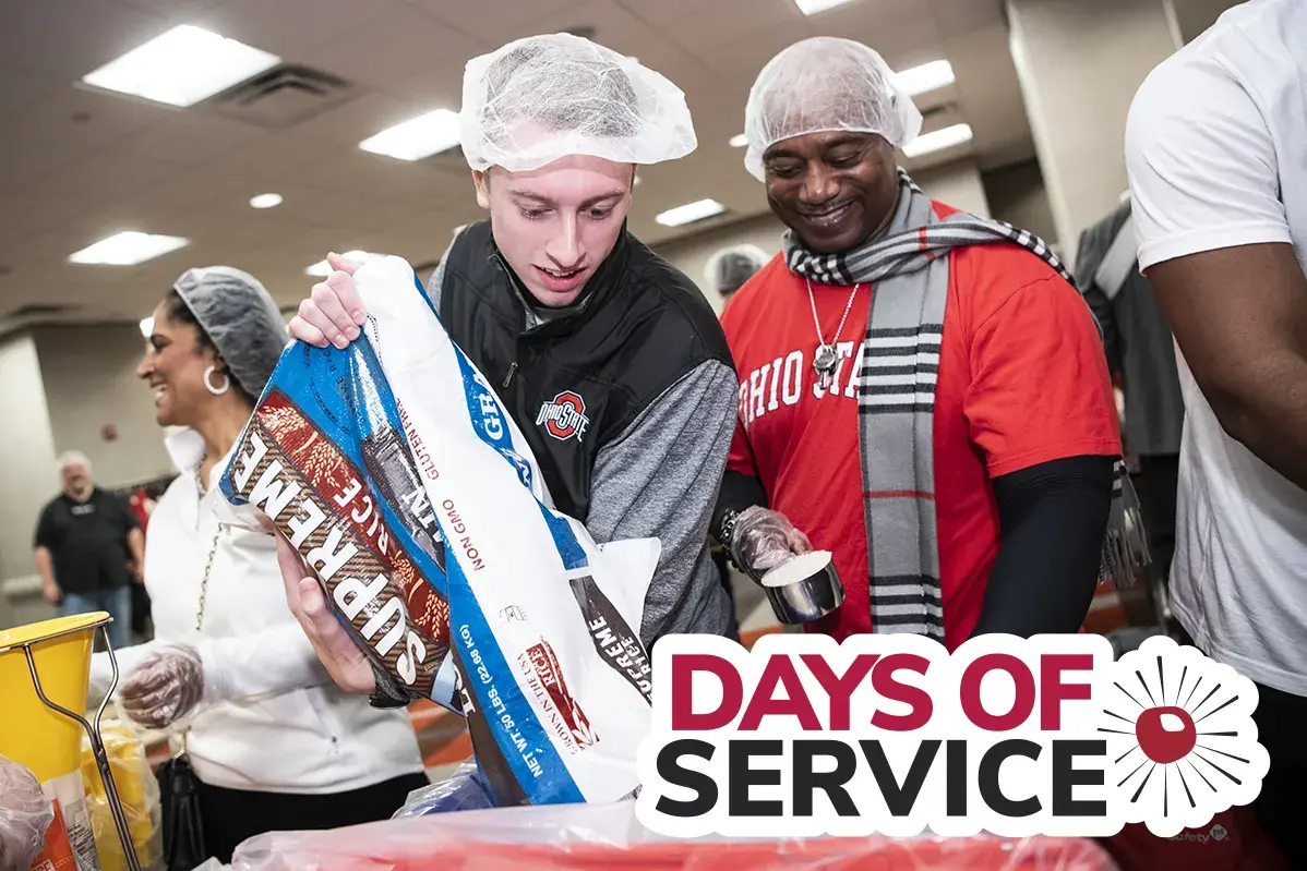 two people at a volunteer event to pack meals