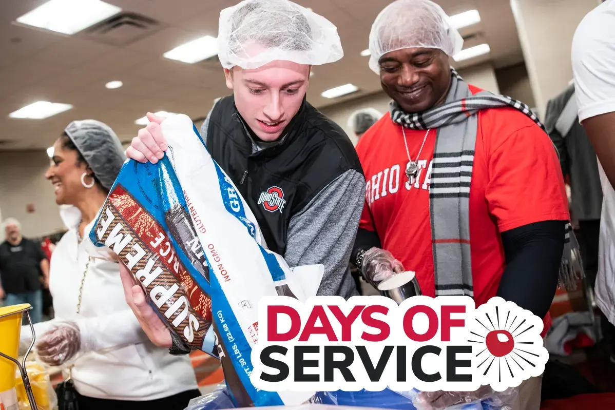 two men participating at a meal packing service event