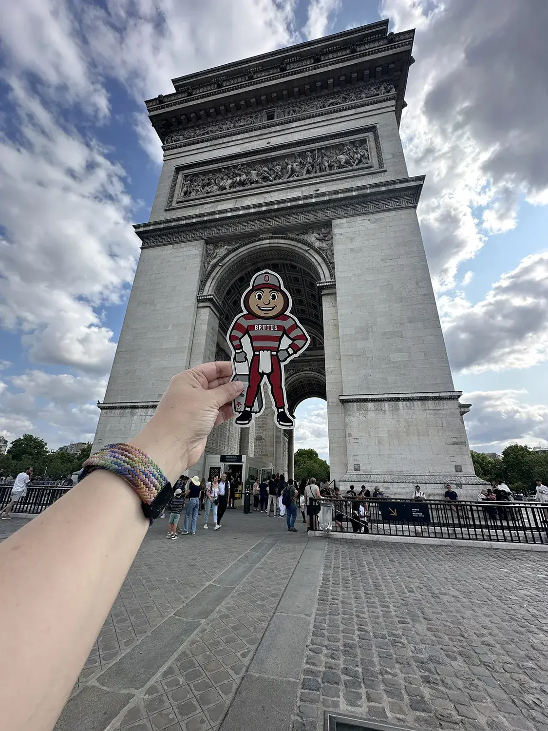 Brutus being held between a grand arch in Paris, France.