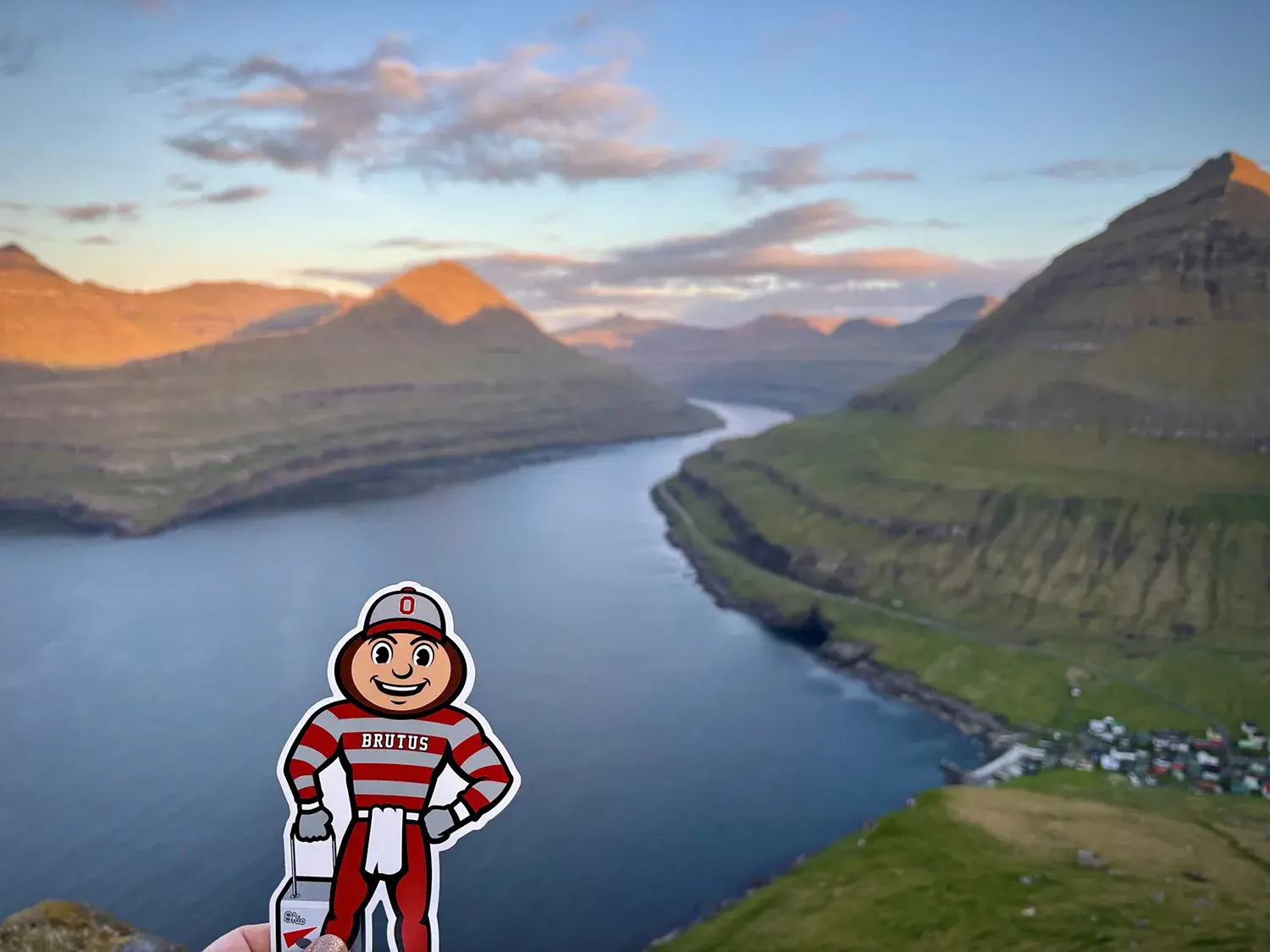 Brutus held up in the foreground of a mountain range in Denmark.