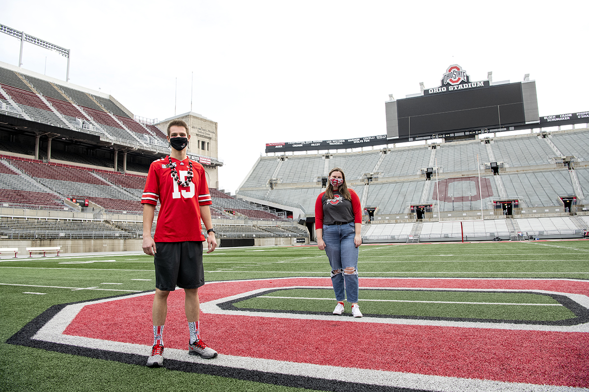 Ohio State students stand at the center of Ohio Stadium.