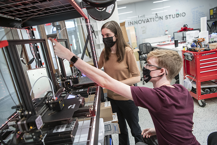 Ohio State student Caroline Karbowski and a fellow student work on a device.