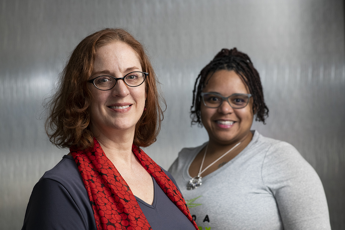Lise Worthen-Chaudhari and Nakia Bridges smile for a portrait. Worthen-Chaudhari is on the left.