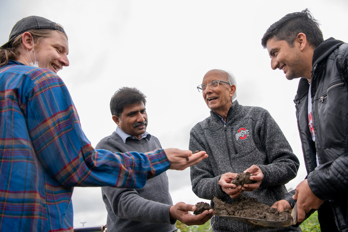 Rattan Lal and a group of researchers look at soil.