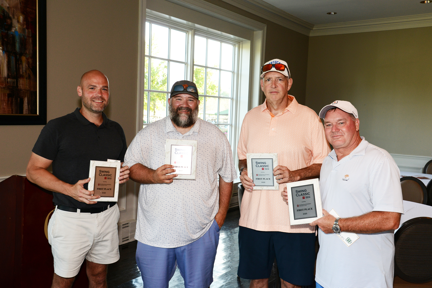 Four individuals standing indoors, each holding a plaque with text including 'Swing Classic 2023' and placement awards such as '1st Place' and '2nd Place.